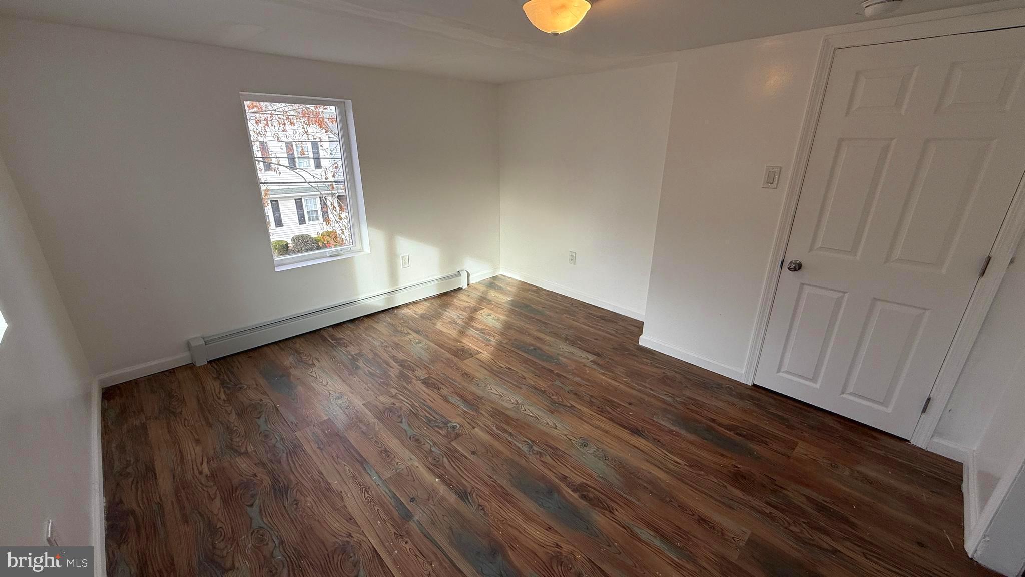 210 Cherry Street Duryea, PA 18642 - Photo 21 of 26 a view of an empty room with wooden floor and a window