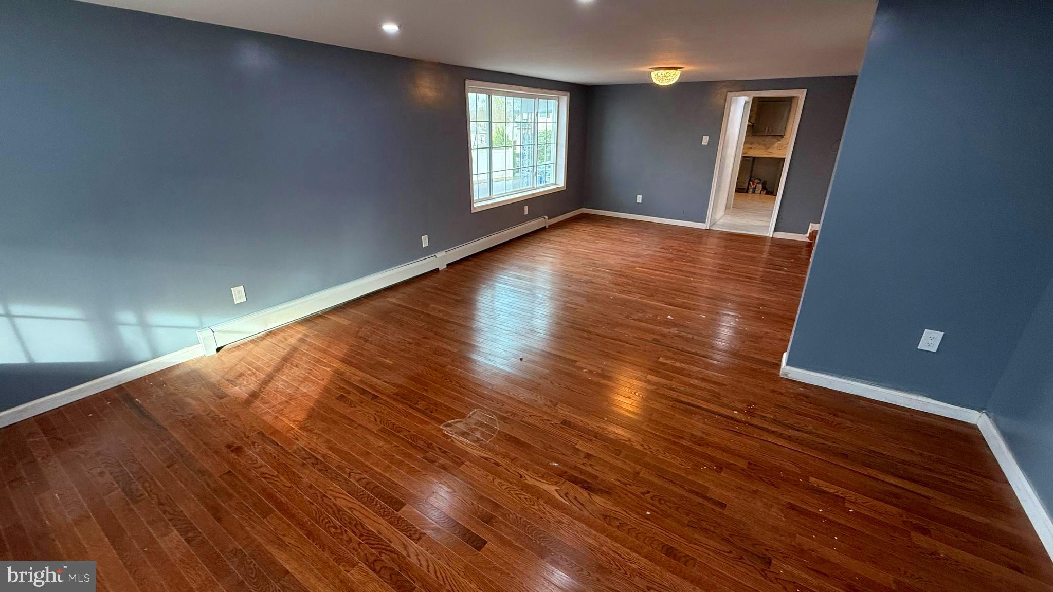 210 Cherry Street Duryea, PA 18642 - Photo 8 of 26 an empty room with wooden floor and windows