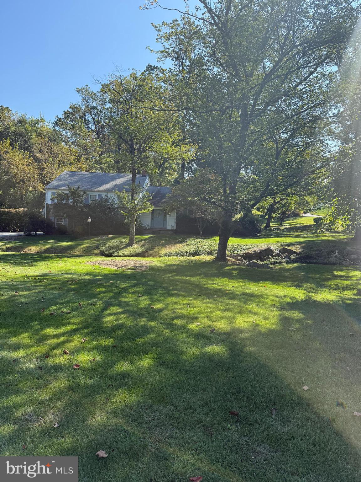 1179 Beaumont Road Berwyn, PA 19312 - Photo 23 of 64 a swimming pool with lawn chairs and large trees