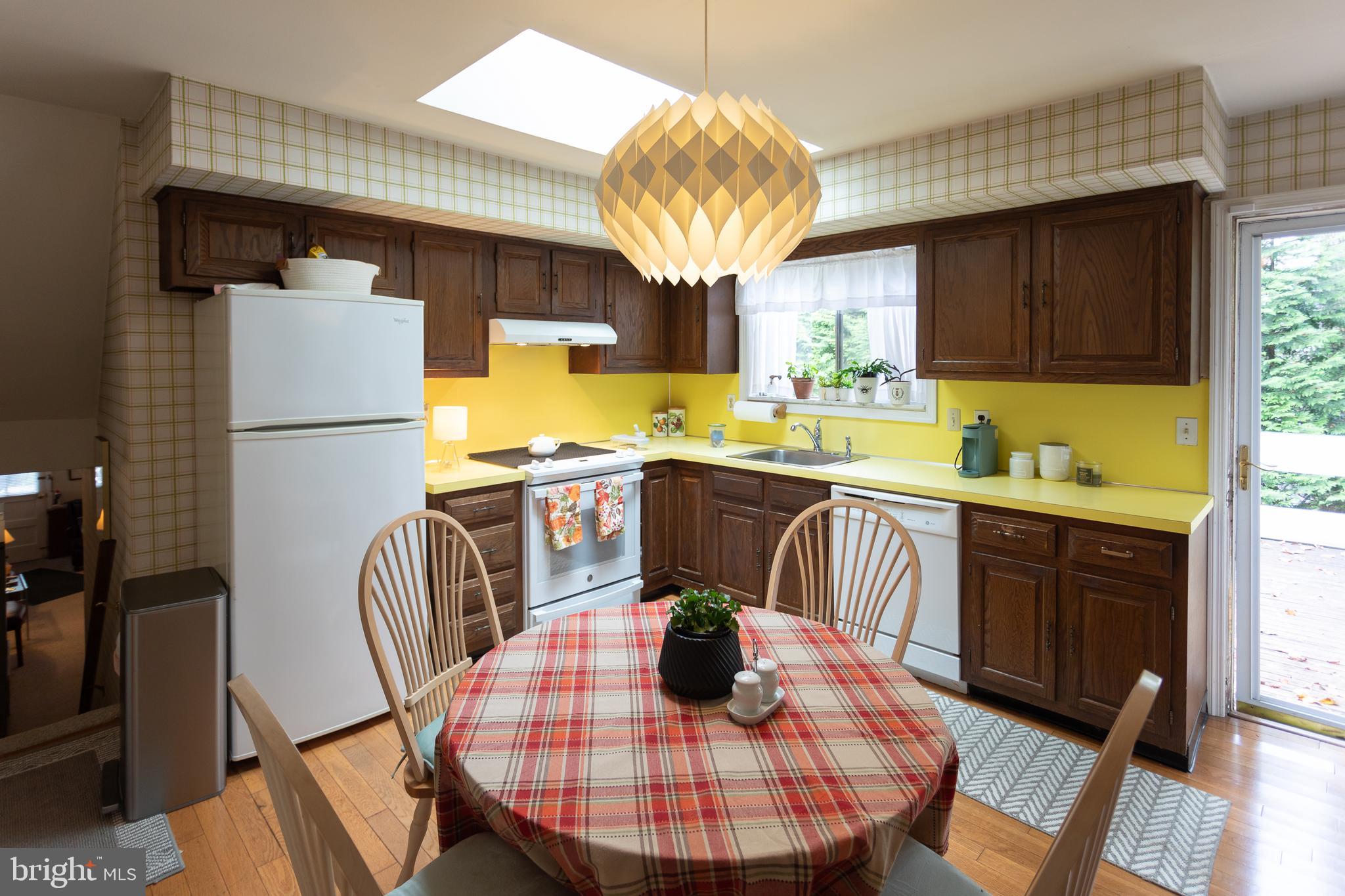 1179 Beaumont Road Berwyn, PA 19312 - Photo 57 of 64 a kitchen with stainless steel appliances granite countertop a refrigerator a sink a stove a dining table and chairs