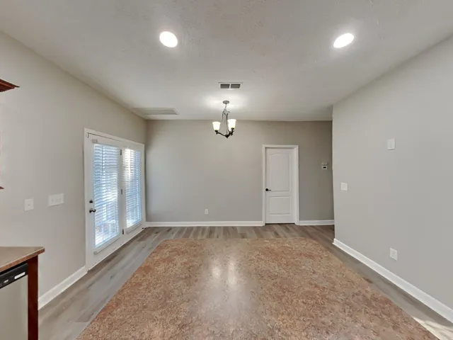 a large kitchen with stainless steel appliances a large counter top a stove a sink and a refrigerator