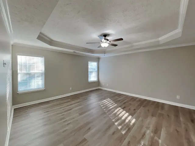 a view of an empty room and wooden floor