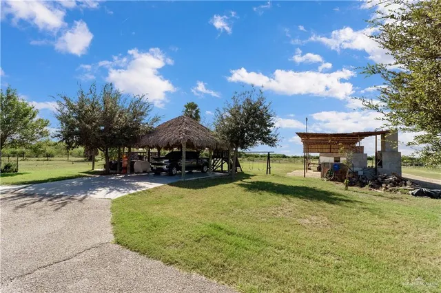 a view of a house with a yard and sitting area