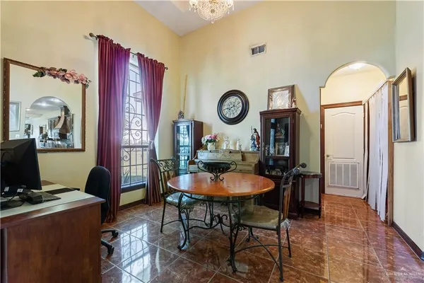 a living room with furniture a computer and a desk