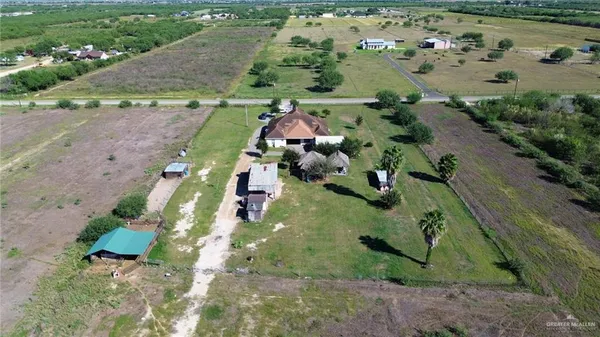 an aerial view of a house with a yard and lake view