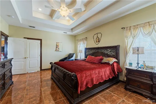 a bedroom with a bed and a chandelier