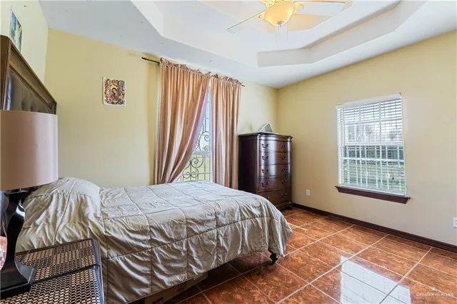 a bedroom with a bed dresser and a window