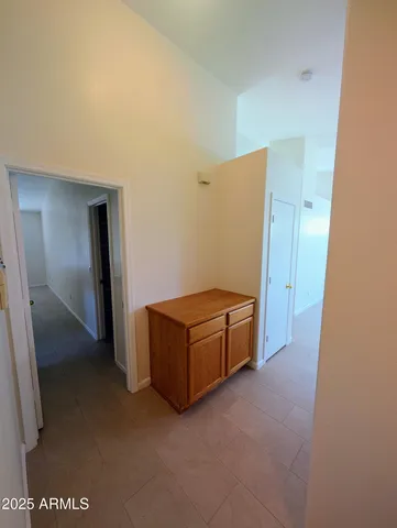a view of a hallway with wooden floor and a window