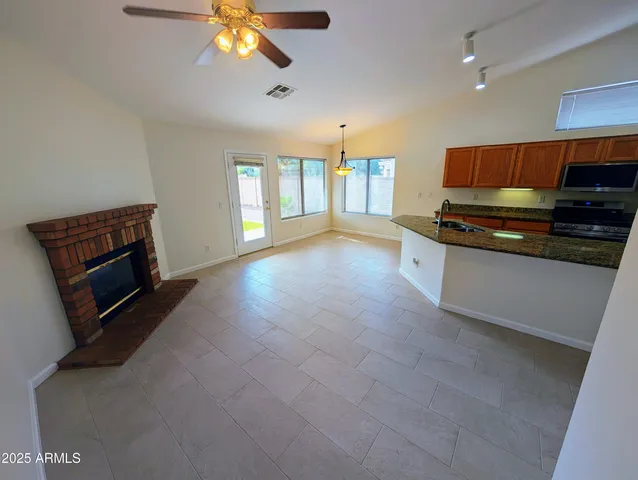 a large kitchen with stainless steel appliances a large counter top