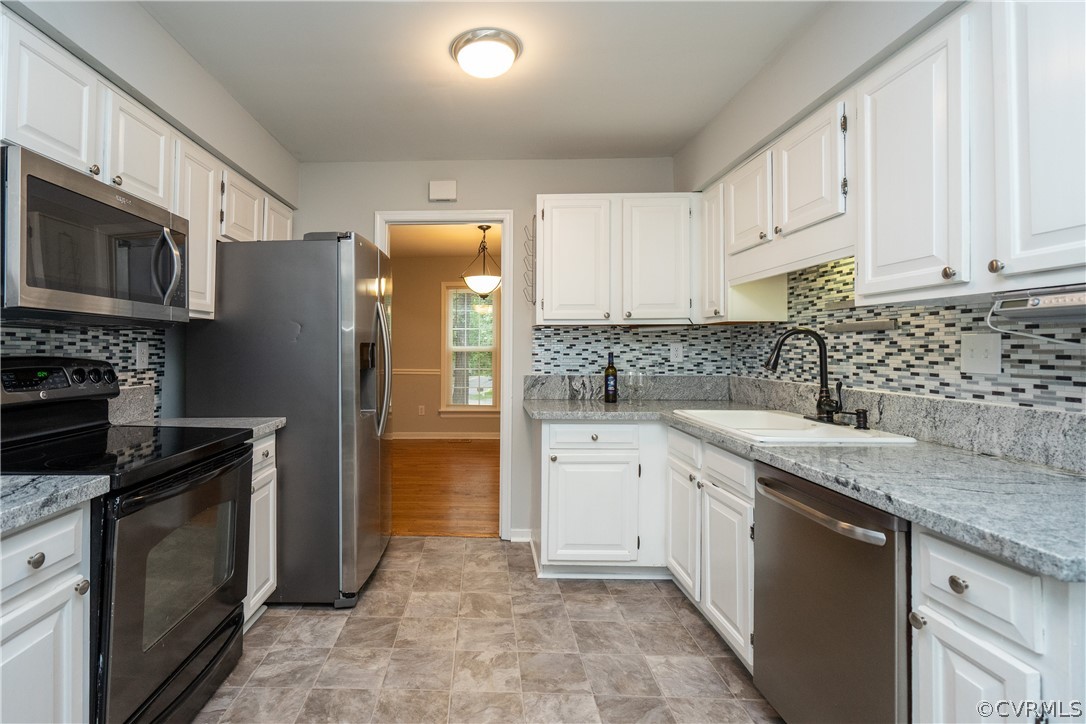 5800 Mill Spring Road Midlothian, VA 23112 - Photo 4 of 22 a kitchen with stainless steel appliances granite countertop a stove a sink and a microwave