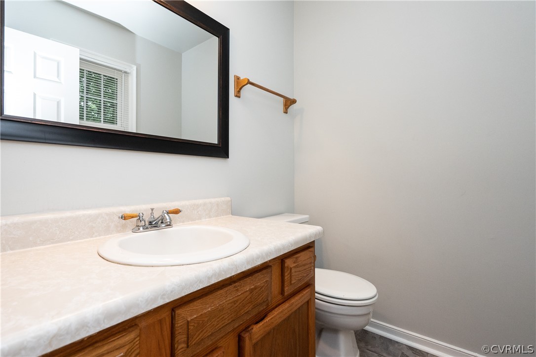5800 Mill Spring Road Midlothian, VA 23112 - Photo 9 of 22 a bathroom with a sink a toilet and mirror