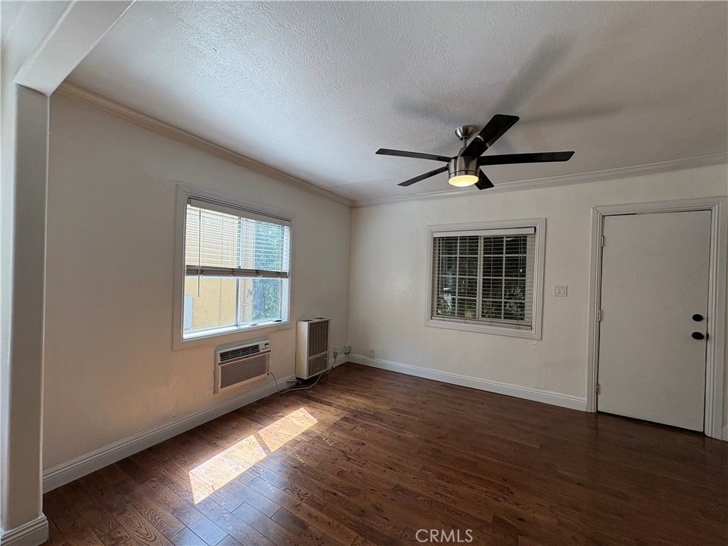 1325 1/2 Douglas Street Los Angeles, CA 90026 - Photo 12 of 23 a view of an empty room with a window and wooden floor