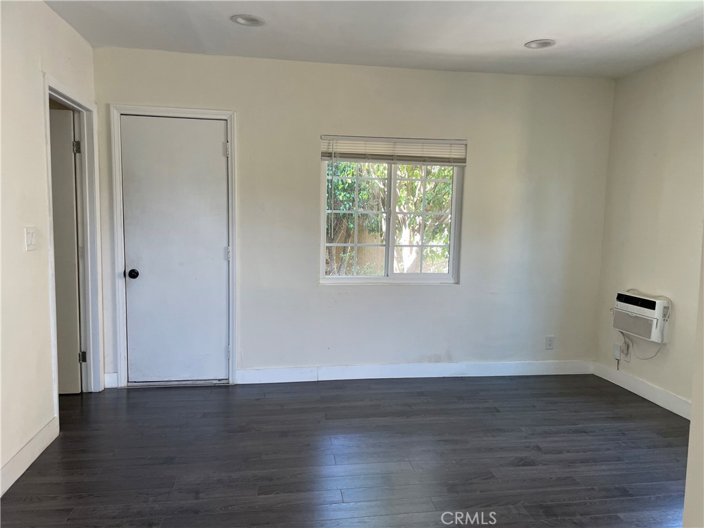 1325 1/2 Douglas Street Los Angeles, CA 90026 - Photo 4 of 23 a view of an empty room with wooden floor and a window