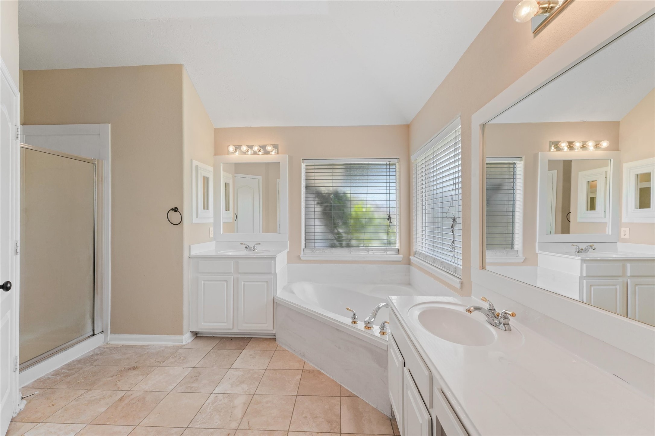 6803 Rhodes Court Missouri City, TX 77459 - Photo 11 of 13 a spacious bathroom with a bathtub sink and mirror