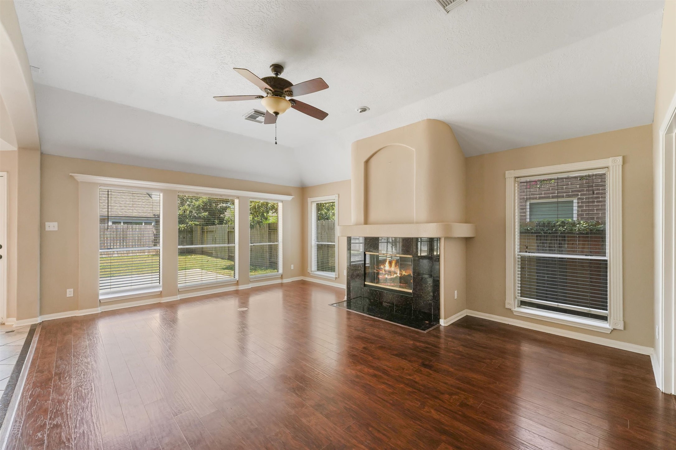 6803 Rhodes Court Missouri City, TX 77459 - Photo 2 of 13 a view of empty room with wooden floor and fan