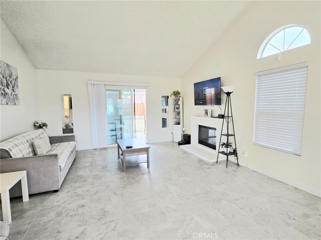 36839 Goldenview Way Palmdale, CA 93552 - Photo 7 of 20 a living room with furniture and a flat screen tv