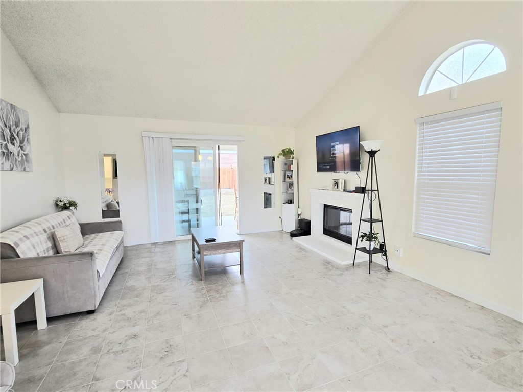 36839 Goldenview Way Palmdale, CA 93552 - Photo 8 of 20 a living room with furniture and a flat screen tv