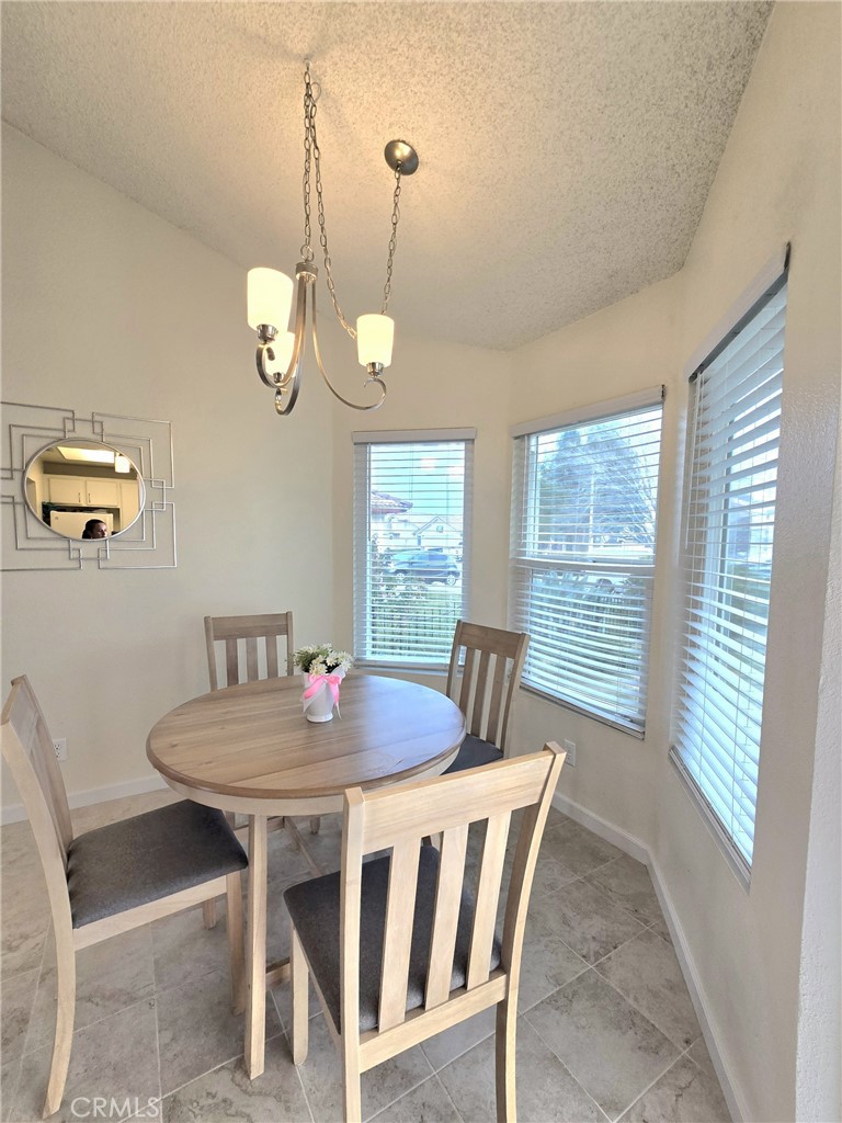 36839 Goldenview Way Palmdale, CA 93552 - Photo 10 of 20 a view of a dining room with furniture window and wooden floor