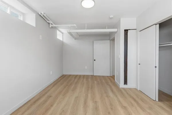 a view of hallway with wooden floor