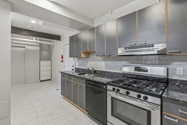 a kitchen with stainless steel appliances granite countertop a stove and a refrigerator