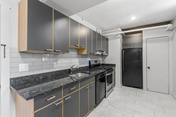 a kitchen with stainless steel appliances granite countertop a sink stove and refrigerator