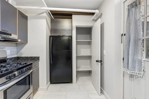 a kitchen with a refrigerator and a stove