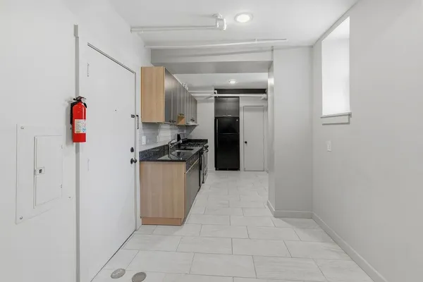a kitchen with refrigerator and cabinets