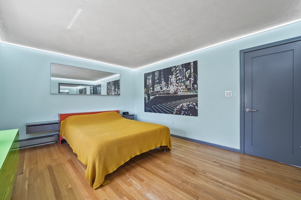 182 Needham Street Dedham, MA 02026 - Photo 11 of 33 a bedroom with a bed and a painting on the wall