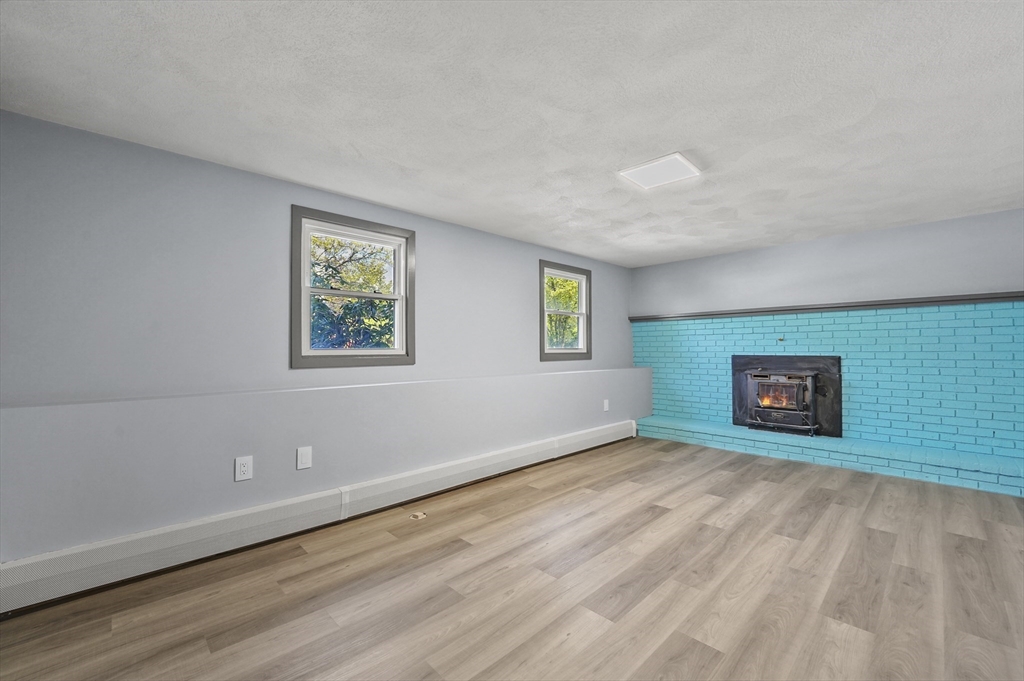 182 Needham Street Dedham, MA 02026 - Photo 18 of 33 a view of an empty room with window and wooden floor