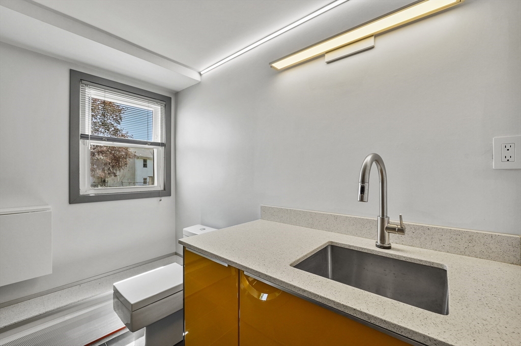 182 Needham Street Dedham, MA 02026 - Photo 20 of 33 a close view of a sink and dishwasher in a kitchen