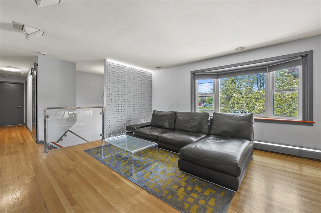 182 Needham Street Dedham, MA 02026 - Photo 2 of 33 a living room with a couch and a table