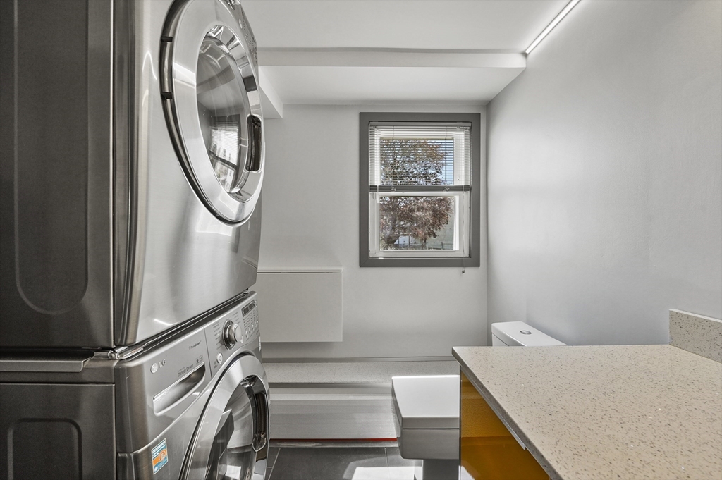 182 Needham Street Dedham, MA 02026 - Photo 21 of 33 a view of a hallway with washer and dryer