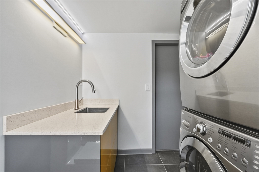 182 Needham Street Dedham, MA 02026 - Photo 22 of 33 a utility room with sink dryer and washer