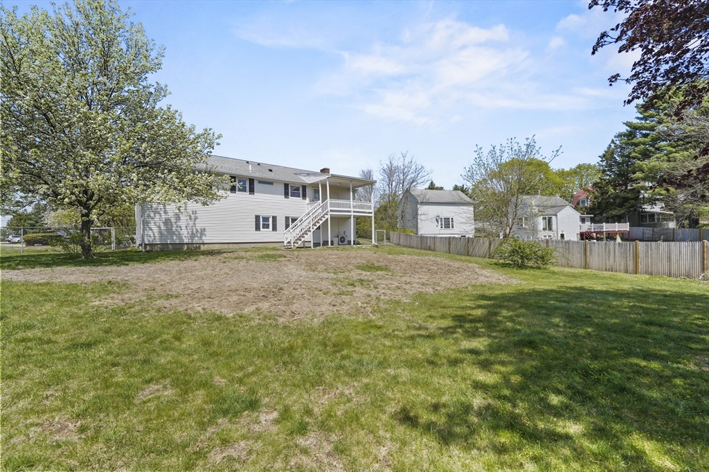 182 Needham Street Dedham, MA 02026 - Photo 26 of 33 a view of a house with a big yard and large trees