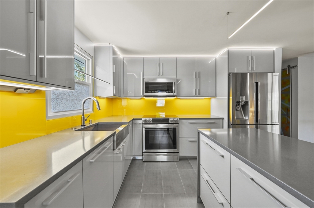 182 Needham Street Dedham, MA 02026 - Photo 8 of 33 a kitchen with stainless steel appliances granite countertop a sink and a microwave