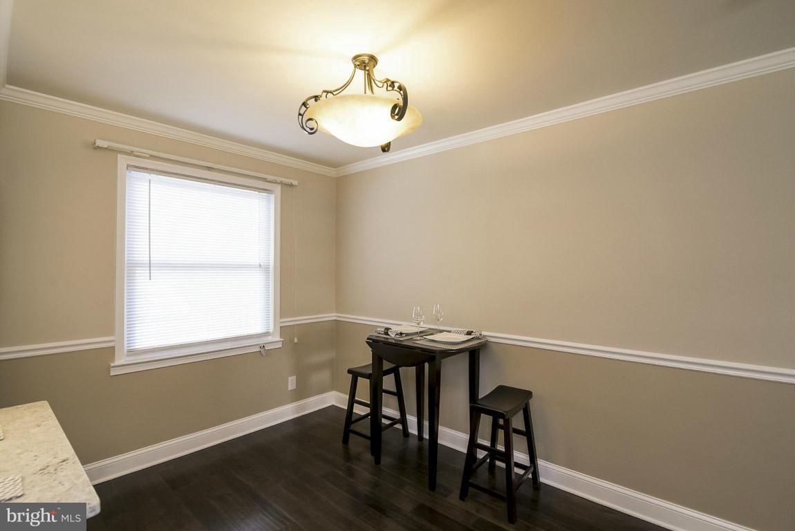 718 Middlesex Road Baltimore, MD 21221 - Photo 11 of 30 a view of a workspace with wooden floor and a window