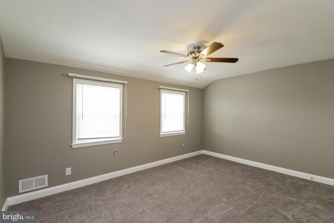 718 Middlesex Road Baltimore, MD 21221 - Photo 15 of 30 an empty room with a window and a fan