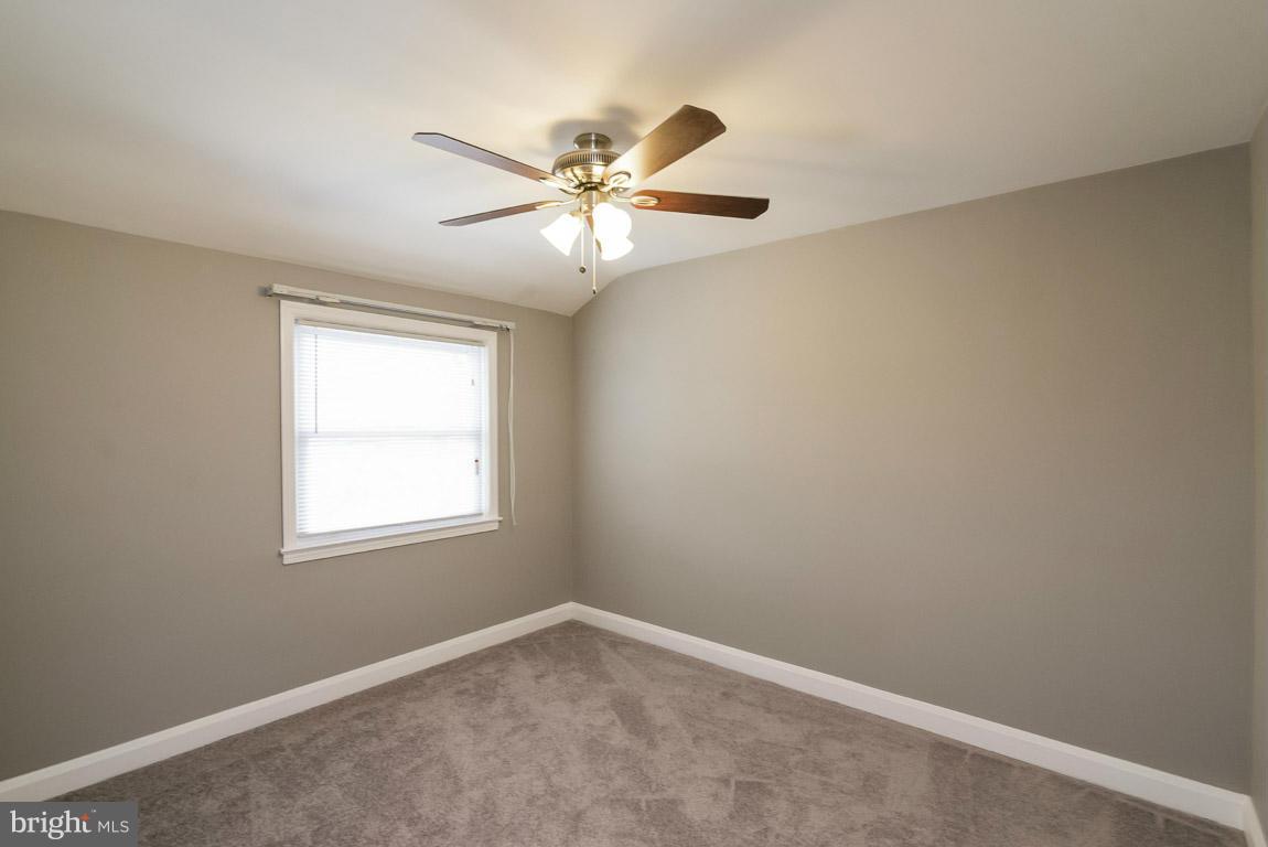 718 Middlesex Road Baltimore, MD 21221 - Photo 16 of 30 an empty room with a window and a fan