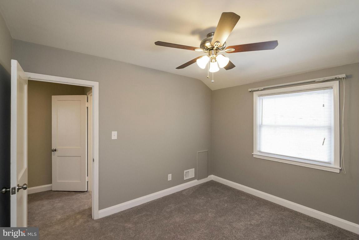 718 Middlesex Road Baltimore, MD 21221 - Photo 17 of 30 an empty room with windows and fan