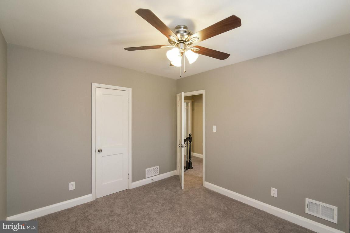 718 Middlesex Road Baltimore, MD 21221 - Photo 18 of 30 an empty room with closet and a ceiling fan