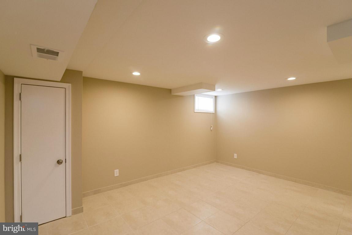 718 Middlesex Road Baltimore, MD 21221 - Photo 25 of 30 an empty room with windows and entrance to other room