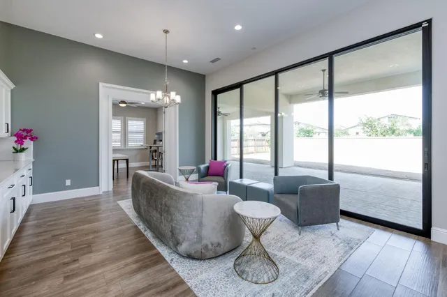 a living room with furniture and wooden floor