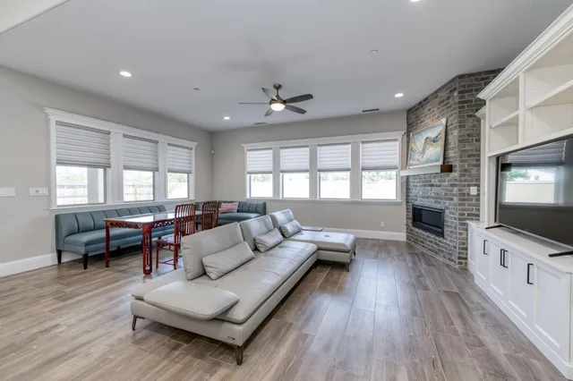 a kitchen with stainless steel appliances a sink dishwasher stove and oven with wooden floor