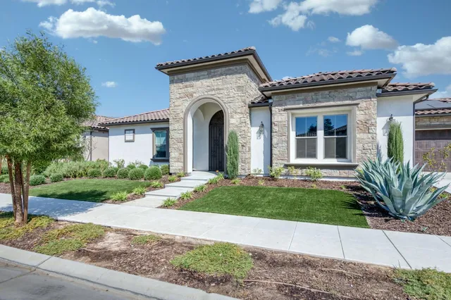 a front view of a house with garden