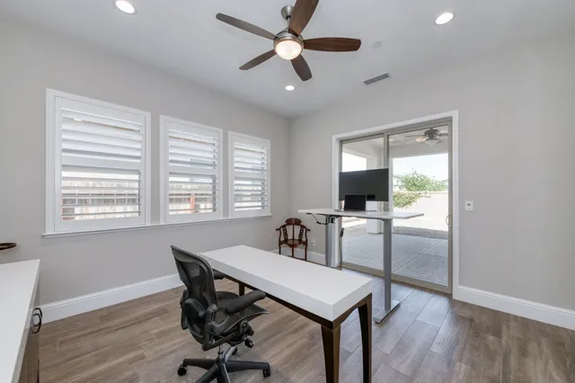 a spacious bathroom with a double vanity sink a mirror and a bathtub next to a window