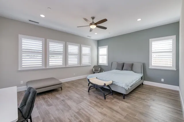 a bathroom with a granite countertop sink mirror and a bathtub