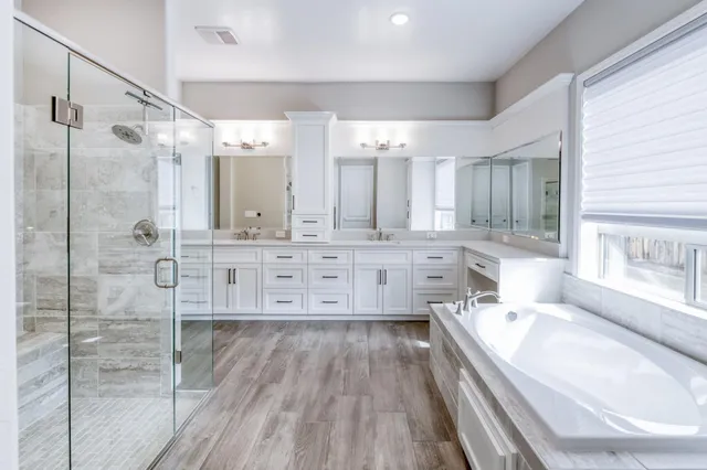 a kitchen with white cabinets and sink