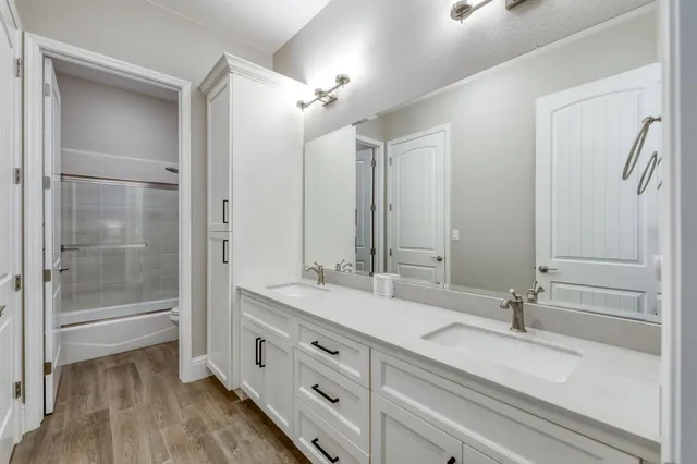 a view of a house with a yard and large trees