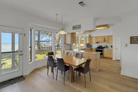 a kitchen with stainless steel appliances granite countertop sink microwave and wooden floor
