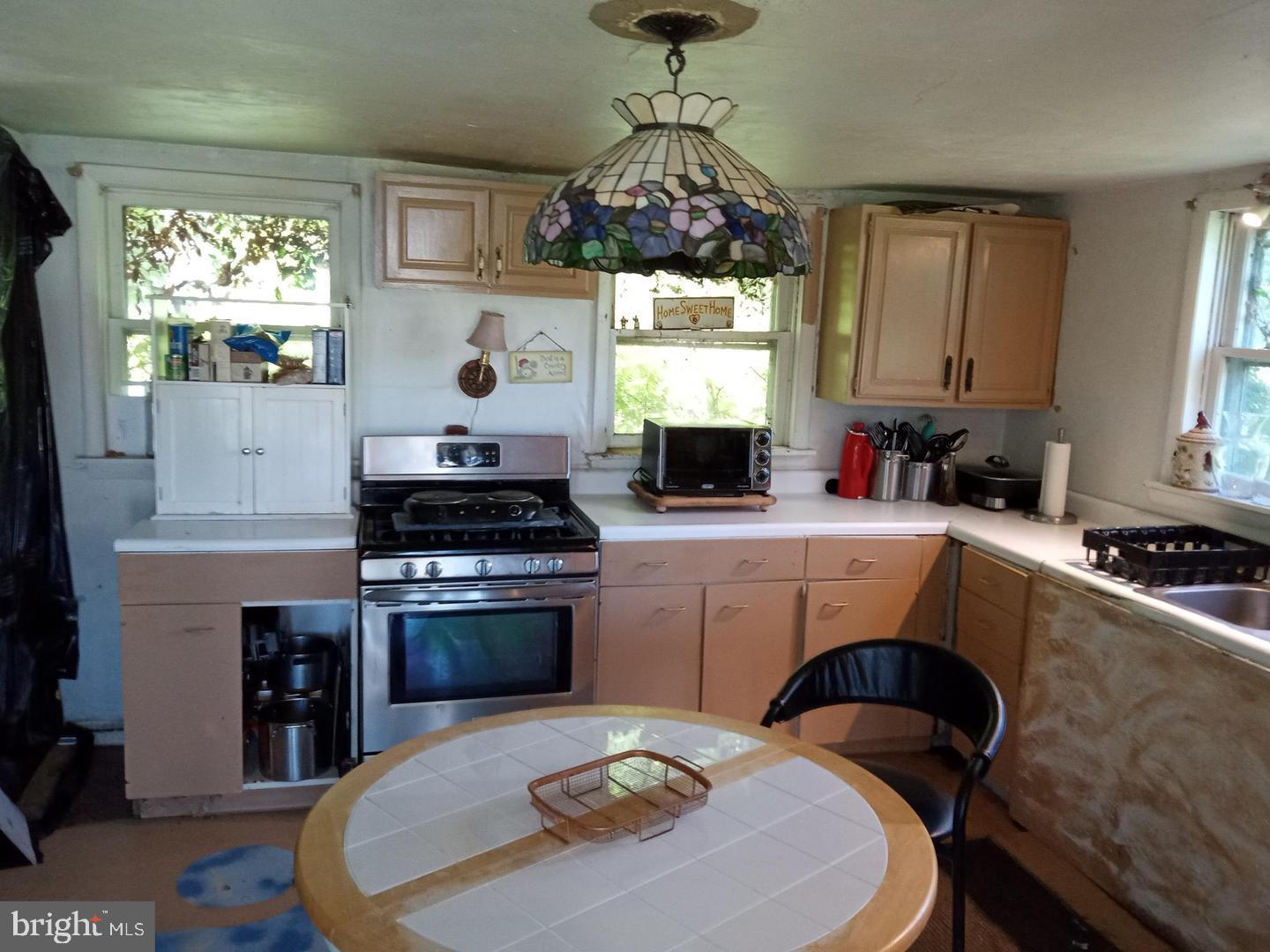 705 Bethel Church Road Middletown, DE 19709 - Photo 5 of 17 a kitchen with kitchen island granite countertop a stove a sink a dining table and chairs